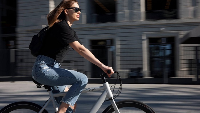 Woman riding bike through city