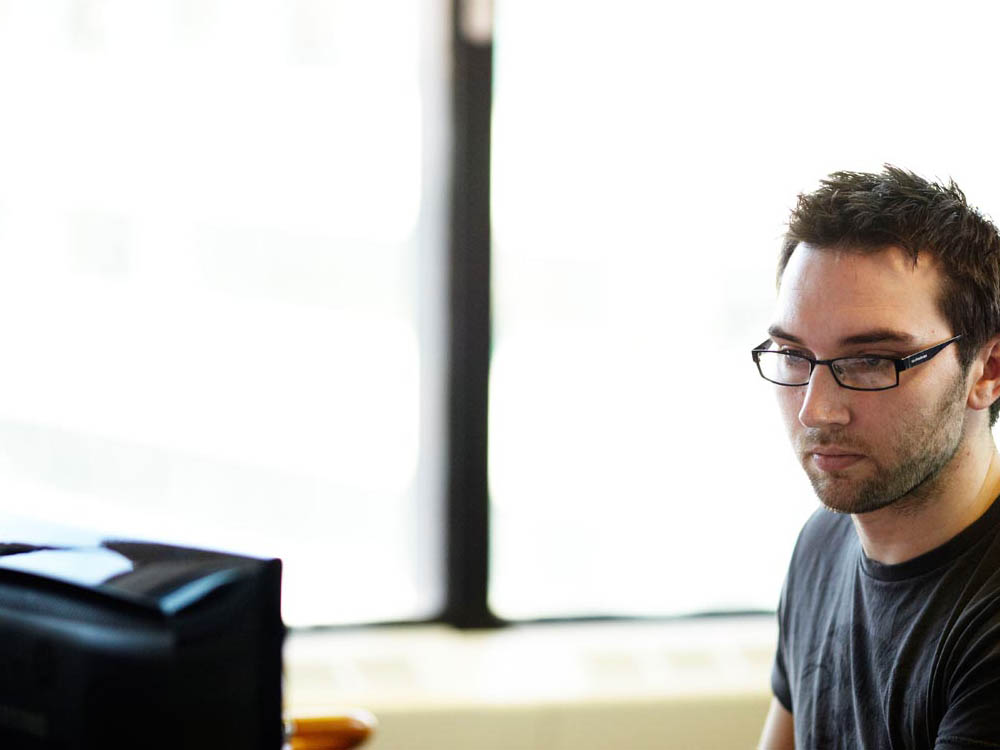Male student looking at computer