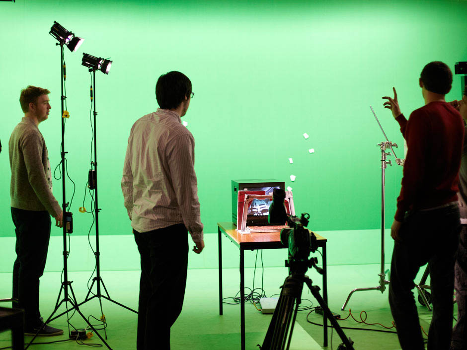 Students in front of green screen