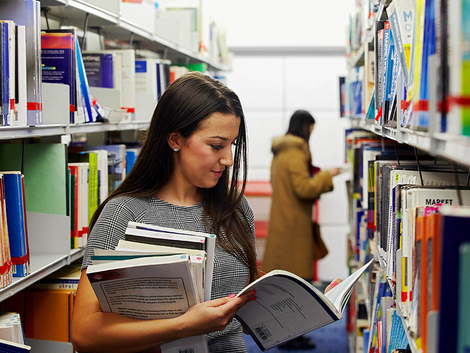 Student with books in library