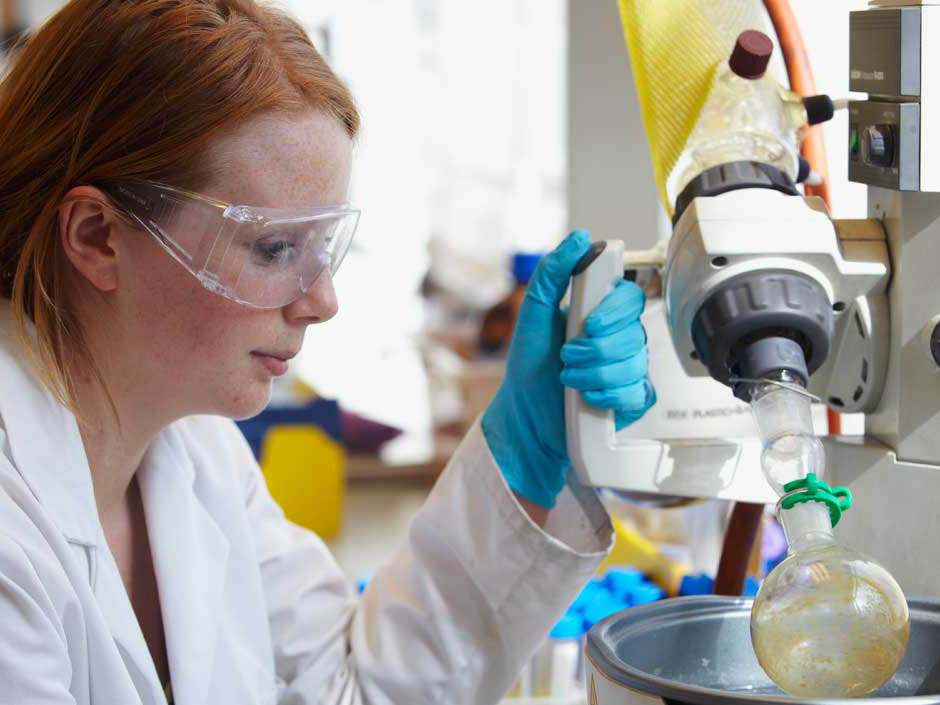 Students in lab coats preparing experiments