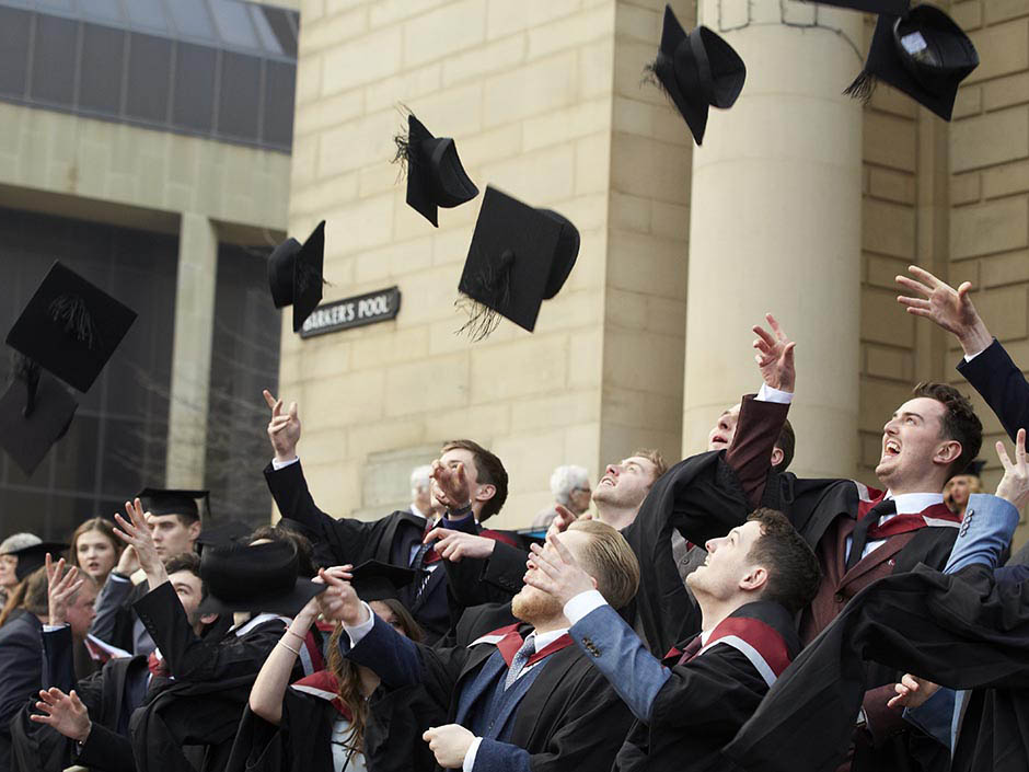 Graduates throwing caps at ceremony