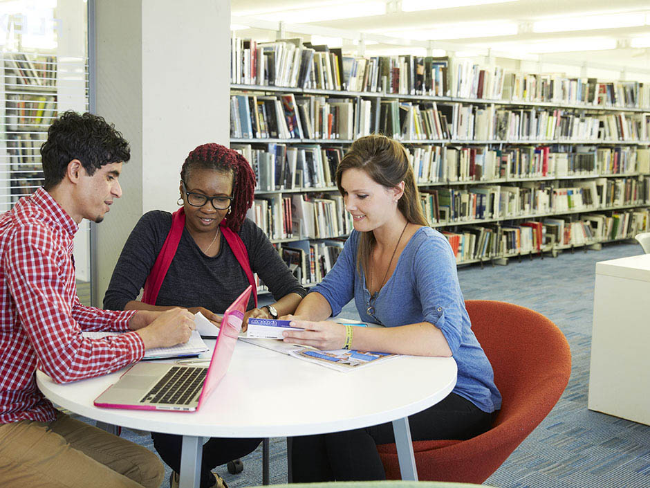 Three students in library