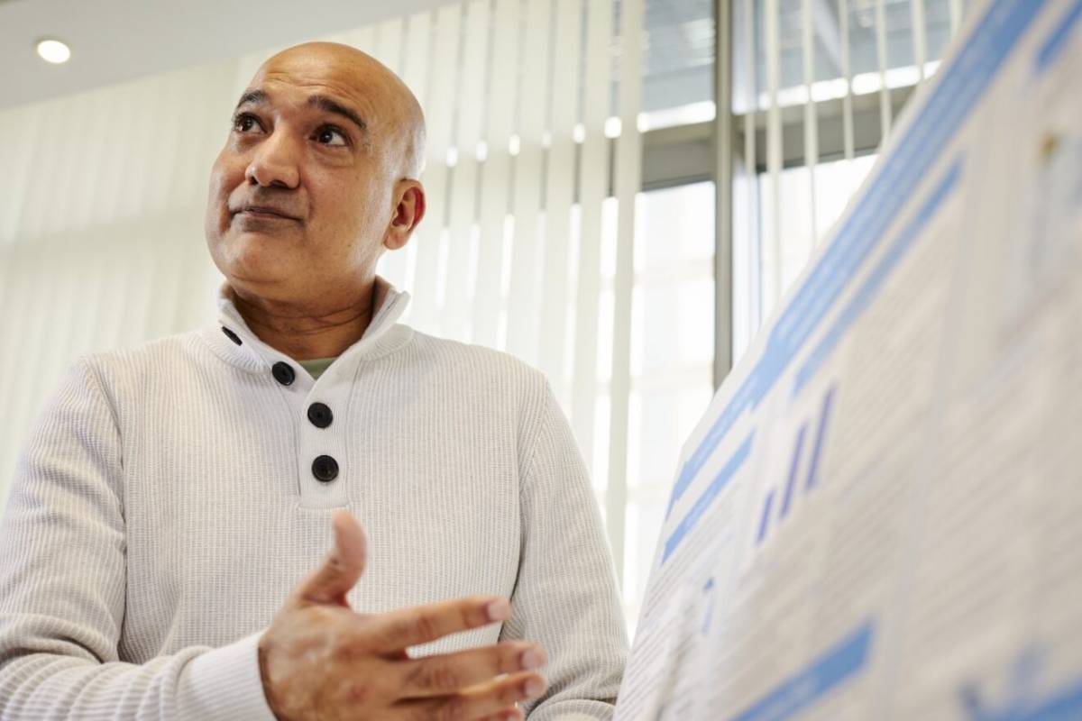 Lecturer holding a poster presentation