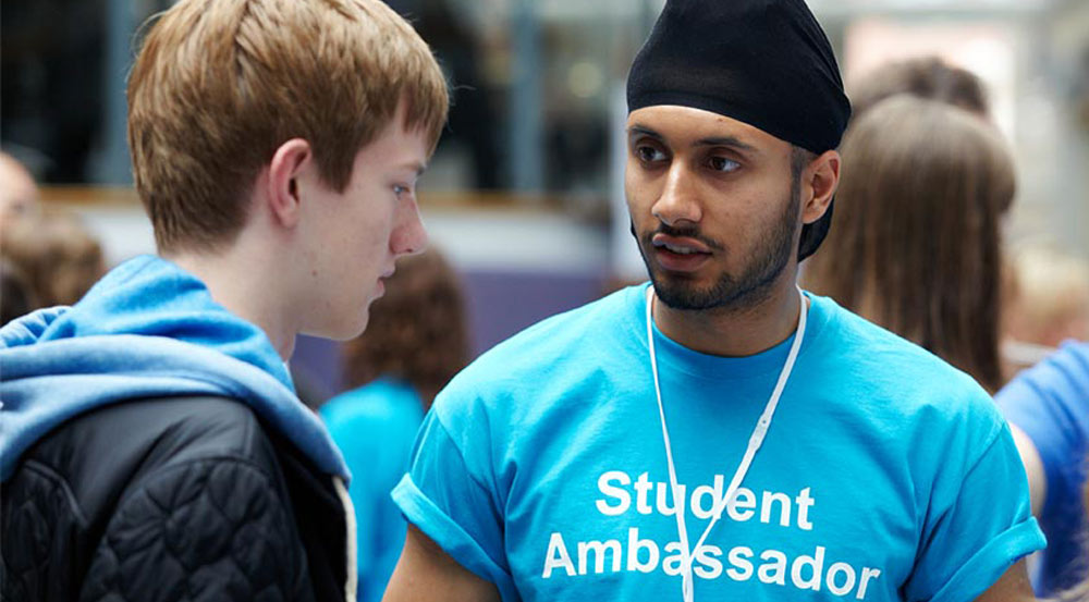 A student ambassador talking to a visitor