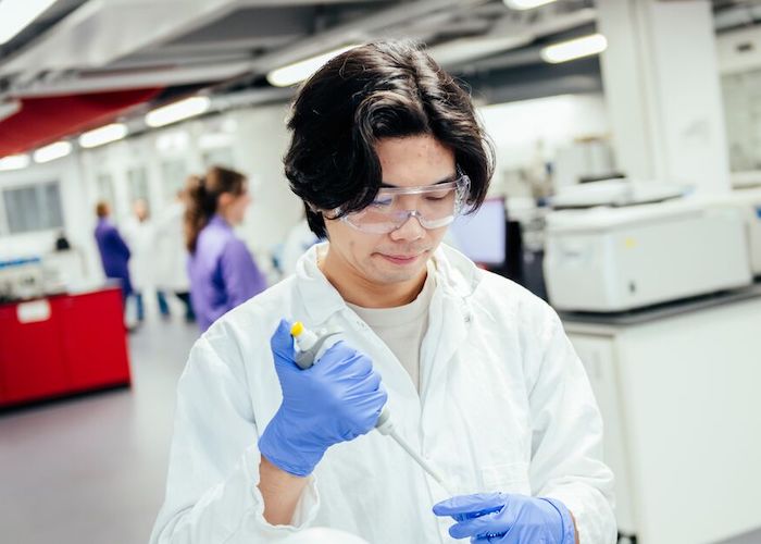 Male student using a pipette in the lab