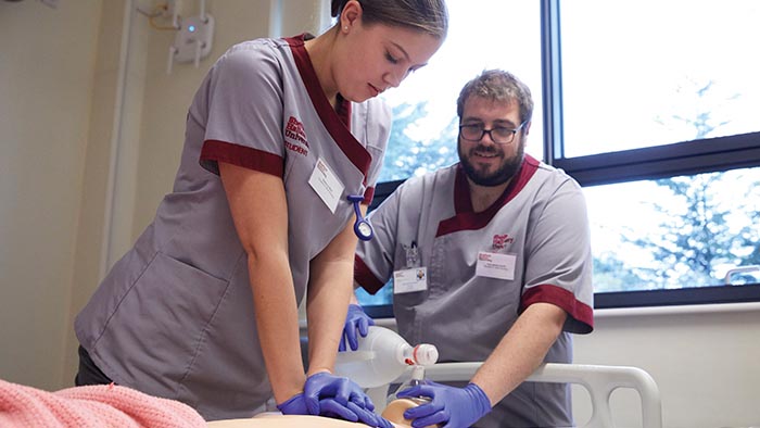 Nurses practicing resuscitation on a dummy