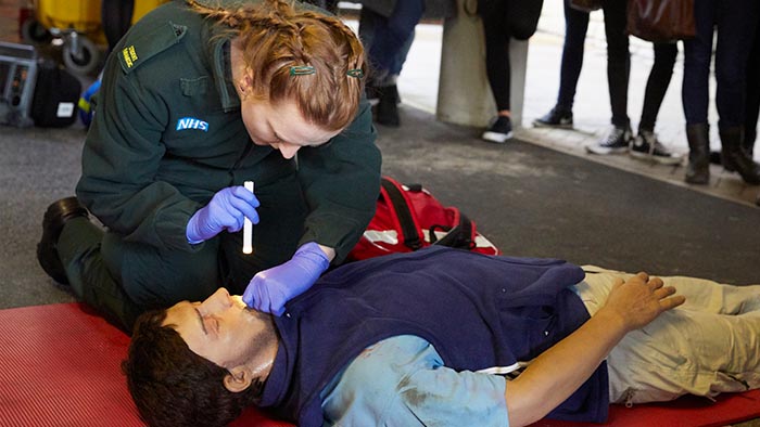 A student practising giving paramedic aid to a dummy