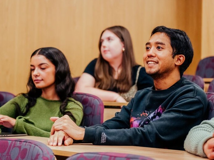 Students are sat in a lecture theatre