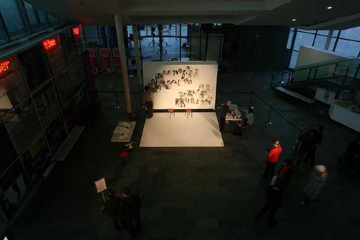 An image from the Arrivals and Departures: New Art Perspectives of Hong Kong exhibition. A series of image on on large white canvas