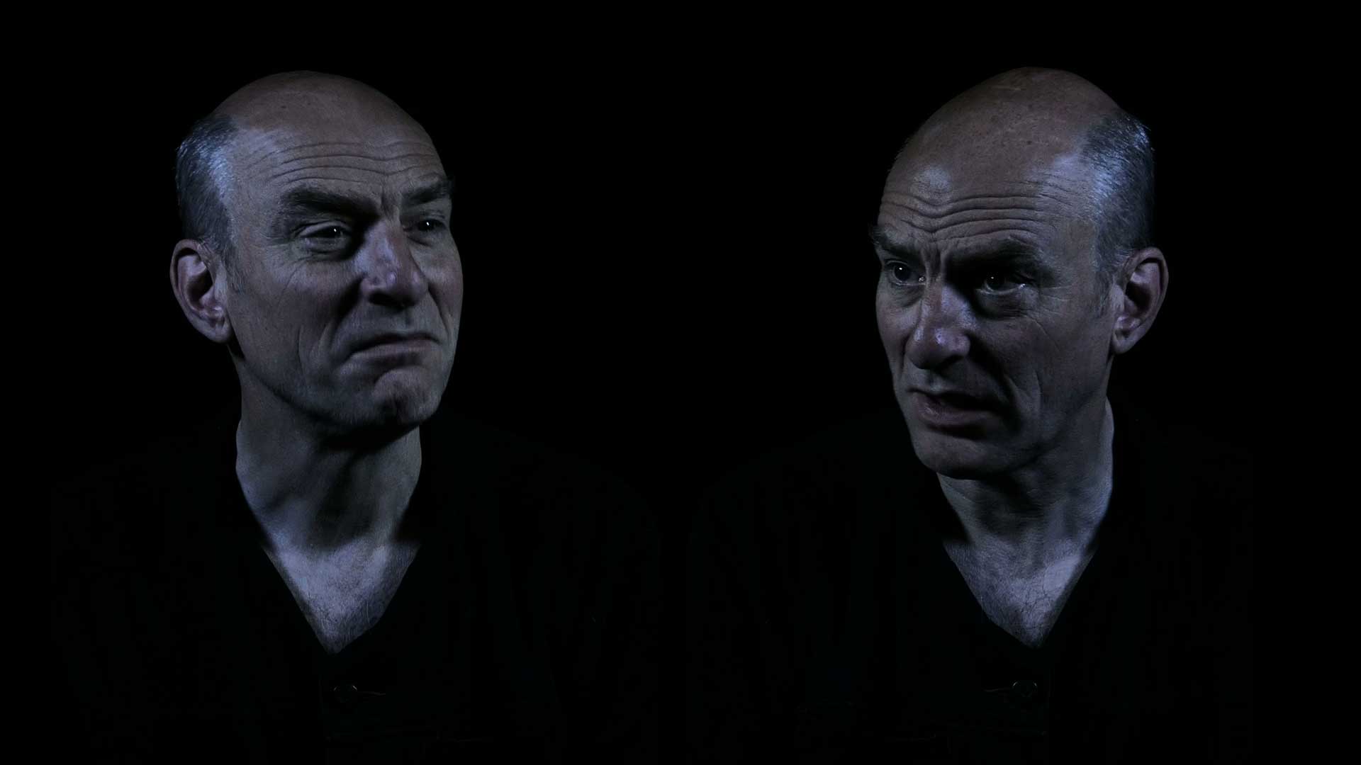 Still of Mirror I by David Cotterrell - An image of a man is displayed on a screen, twice with different expressions.