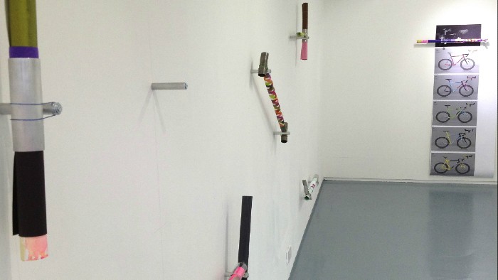 Metal pieces from the Dazzle project mounted on a white wall in an exhibition