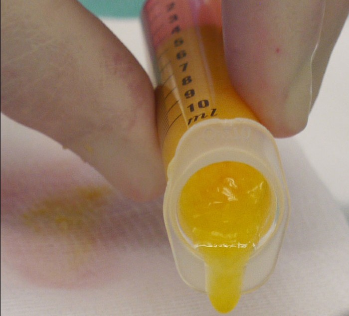 Piece of art from excessories project. Yellow liquid coming out of a vial 