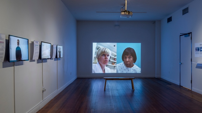 Exhibition with film being played on a screen