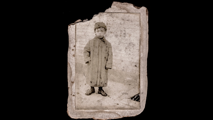 Vintage photo of a young boy in a long coat - from the The Archive by Peter Spence