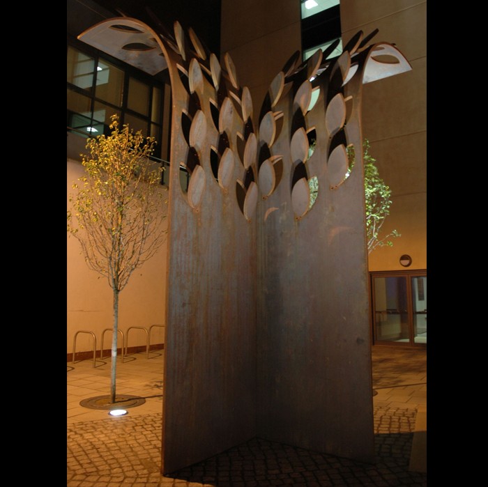 An erected piece of metal work. Two pieces of metal stood perpendicular to each other with a wheat shape at the top of each