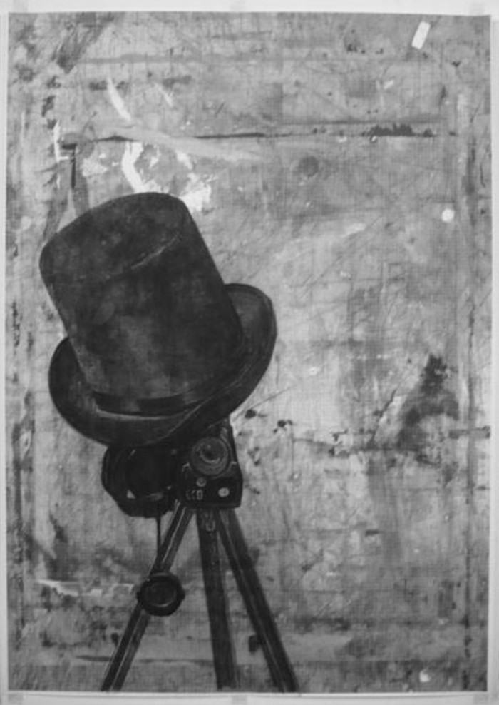 A piece from the imposter series project. A top hat sits on top of a vintage camera on a tripod