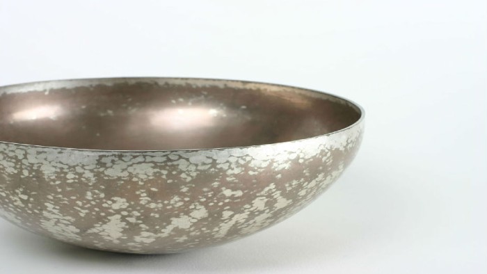 A bowl made using Japanese alloying and patination. It is a sliver and pewter colour.