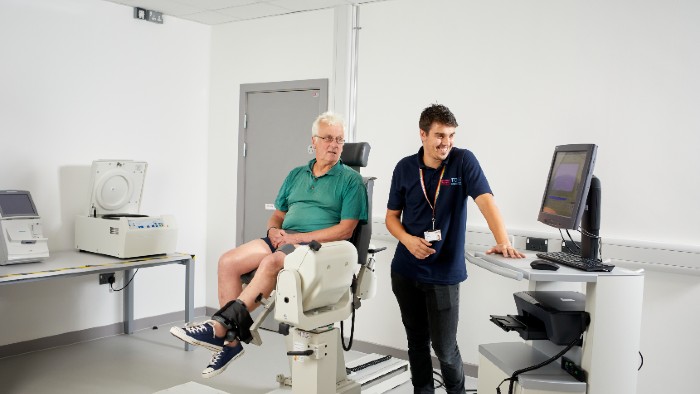 Man and clinician using physio equipment