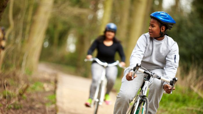 Teenage boy and mum on bikes in the wood