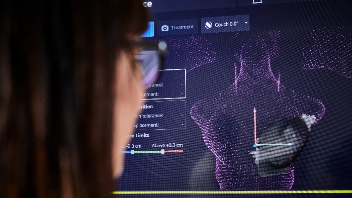 Someone looking at a 3D surface scan of the radiotherapy bra