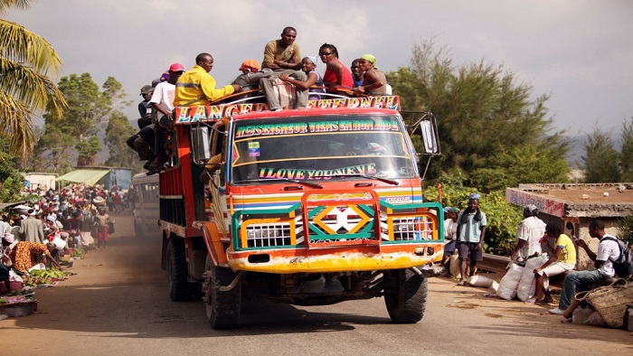 Group of people travelling on a top of a truck