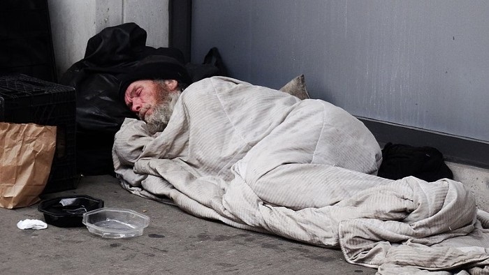 A homeless person sleeping on the street