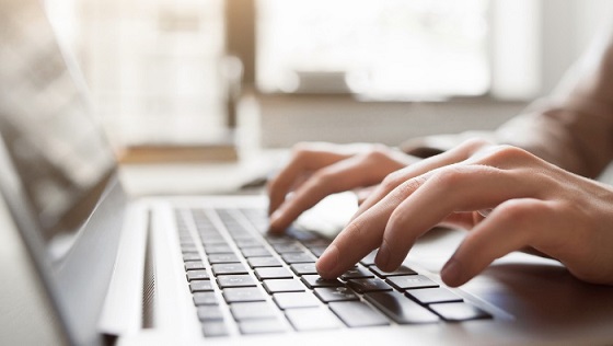 a person typing on their computer