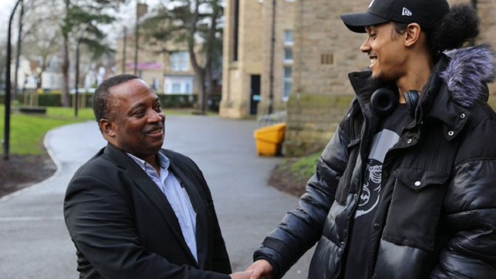 Dr Bankole Cole shaking hands with Blair Adderley