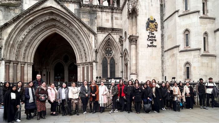 Students and staff standing outside the Royal Court of Justice
