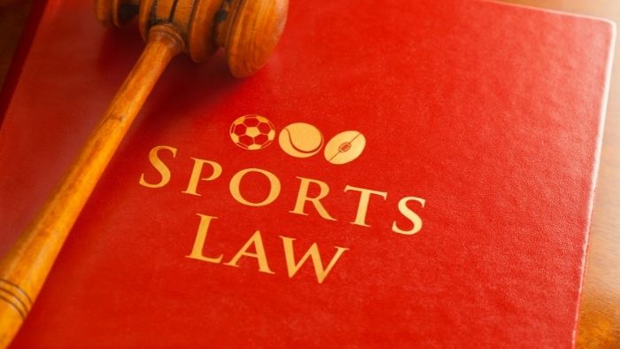 A red folder with Sports Law sign on it and a gavel