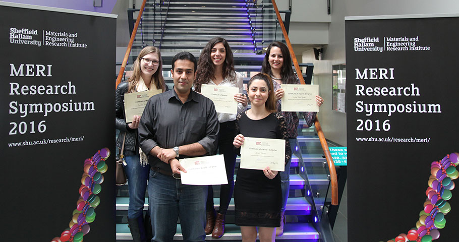 Prize winning students displaying research symposium cerrtificates