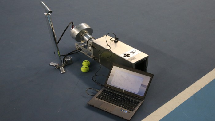 Pace testing equipment being used on a tennis court to measure the pace tennis balls are travelling at