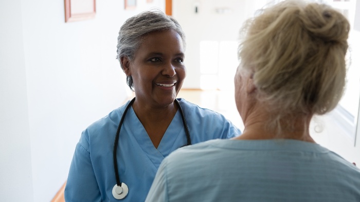 A community nurse talking to a patient