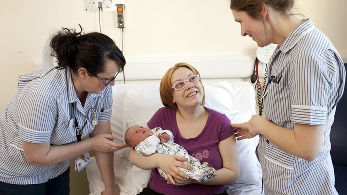 New mother with two midwives