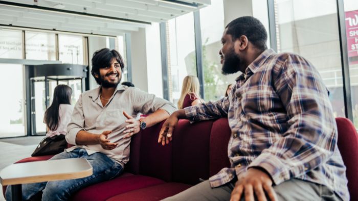 Students collaborating on seats in Sheffield Business School