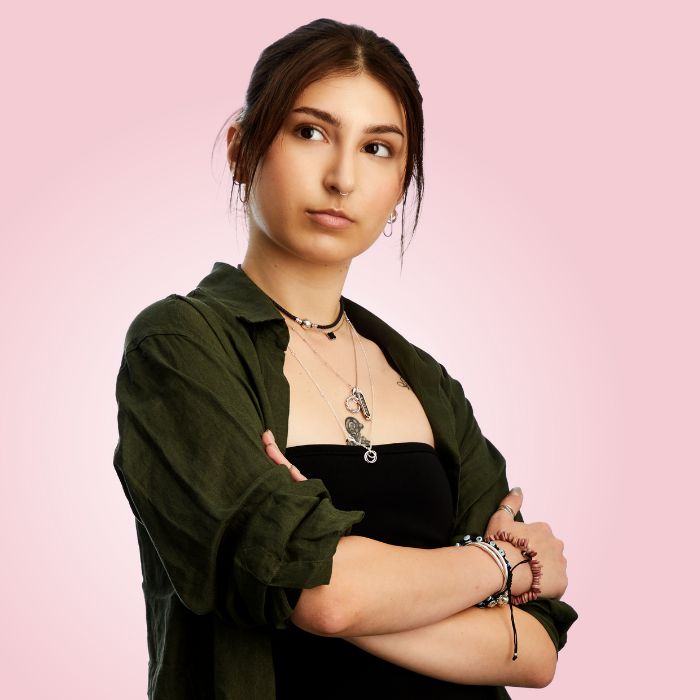 Young woman looking confident on pink background