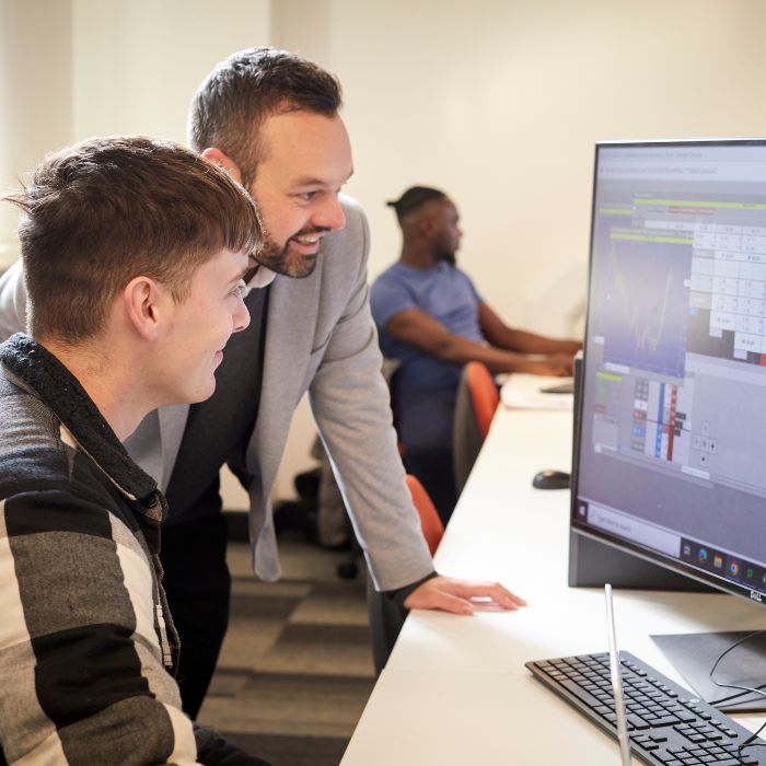 Finance student looking at screen with tutor