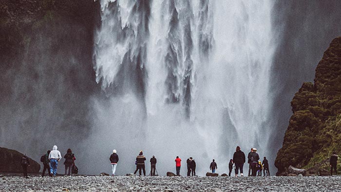 International students stood in front of a waterfall