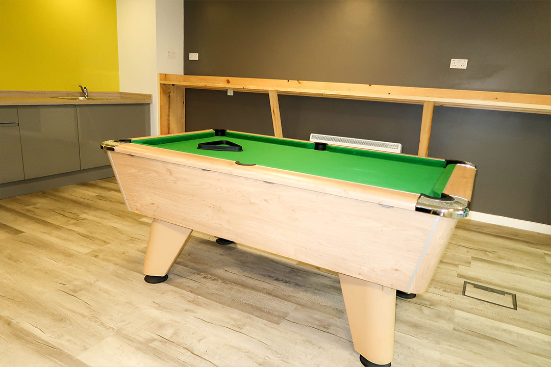 Common room with pool table, ping pong, games console and dartboard