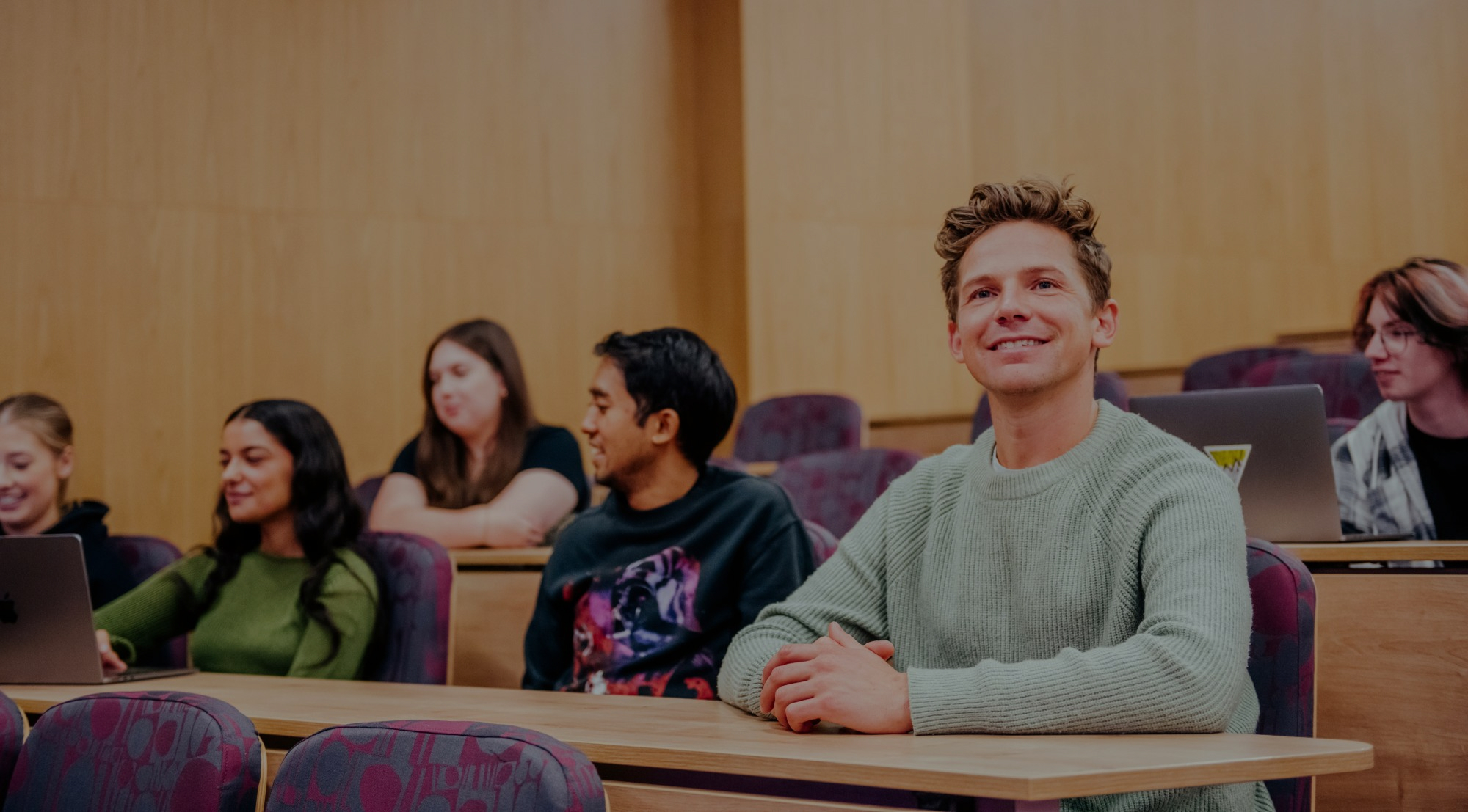 Group of students sat in a lecture theatre
