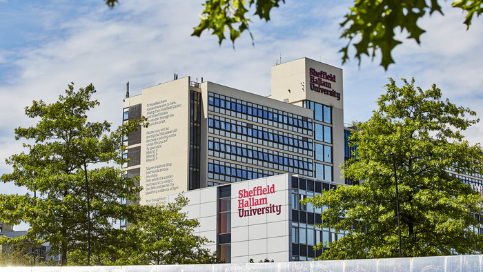 A view of Sheffield Hallam City Campus building with trees in the foreground.