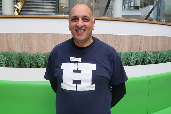 Parent ambassador Zahid stood for a photo at an open day wearing a Team Hallam tshirt.