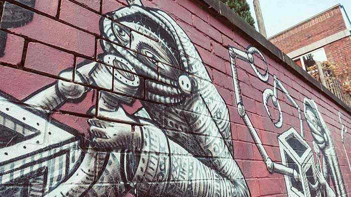 Mural by street artist Phlegm – a complex black and white figure on a city wall
