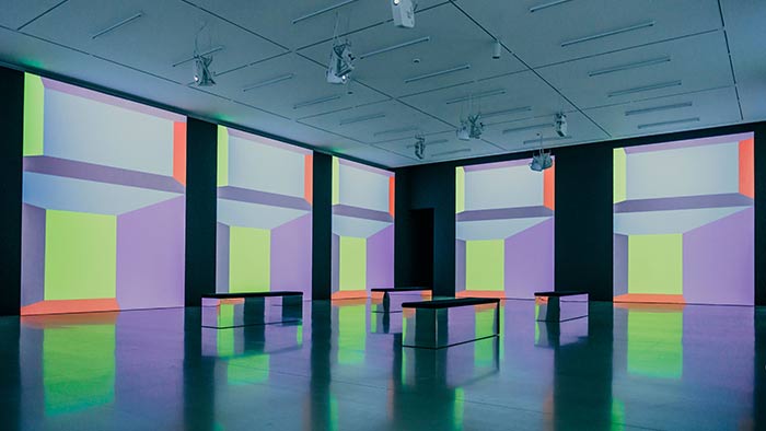 Millennium Gallery interior – benches in a large gallery space, with digital art projected on the walls