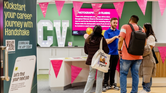 Students chatting to a careers adviser at a job fair