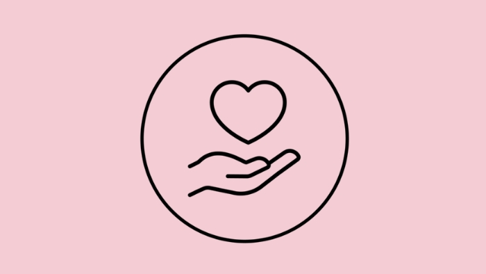 Light pink background with a love heart over an open hand
