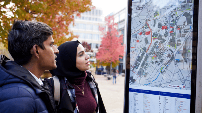 students looking at bus times