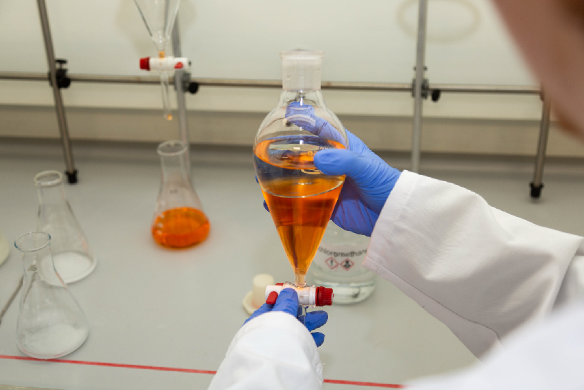 Bioscience experiment with a orange liquid in test tubes
