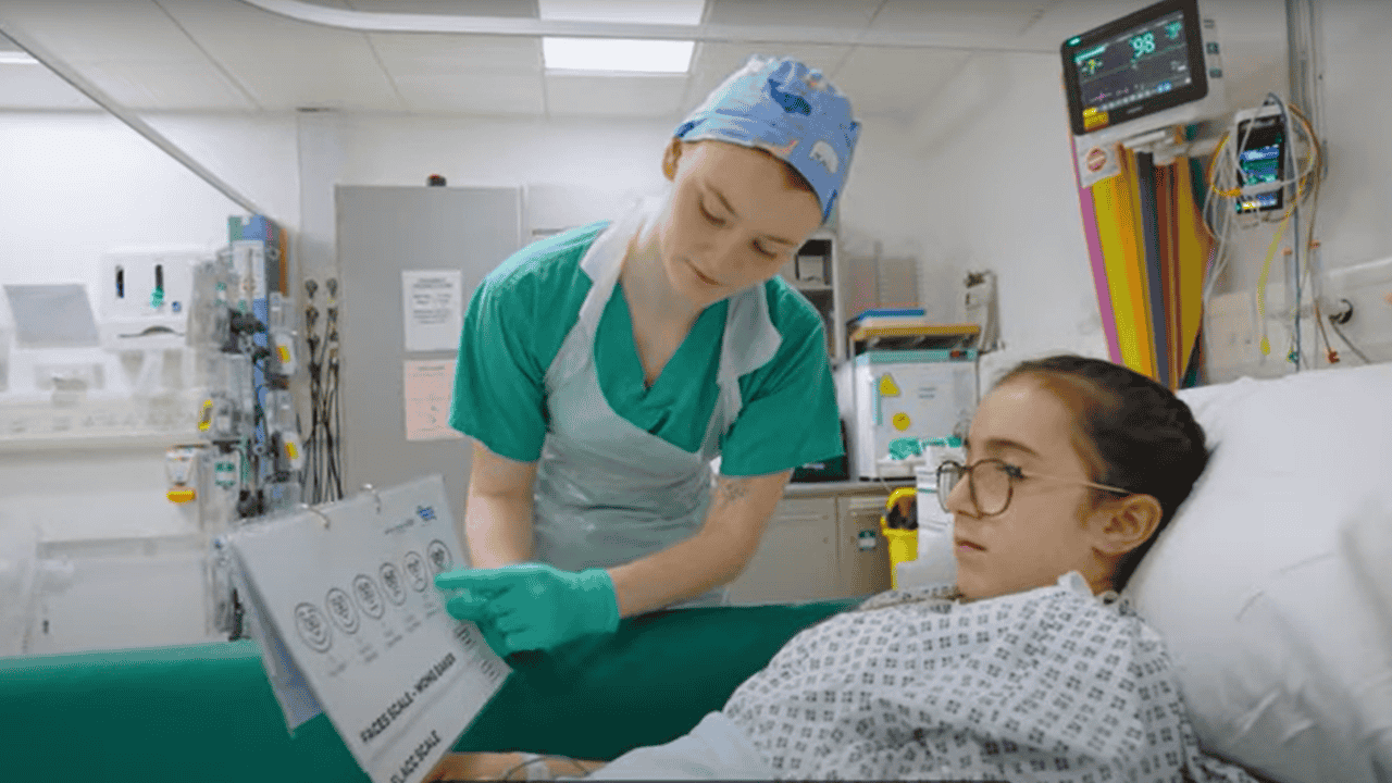 Student working in surgical recovery with child patient